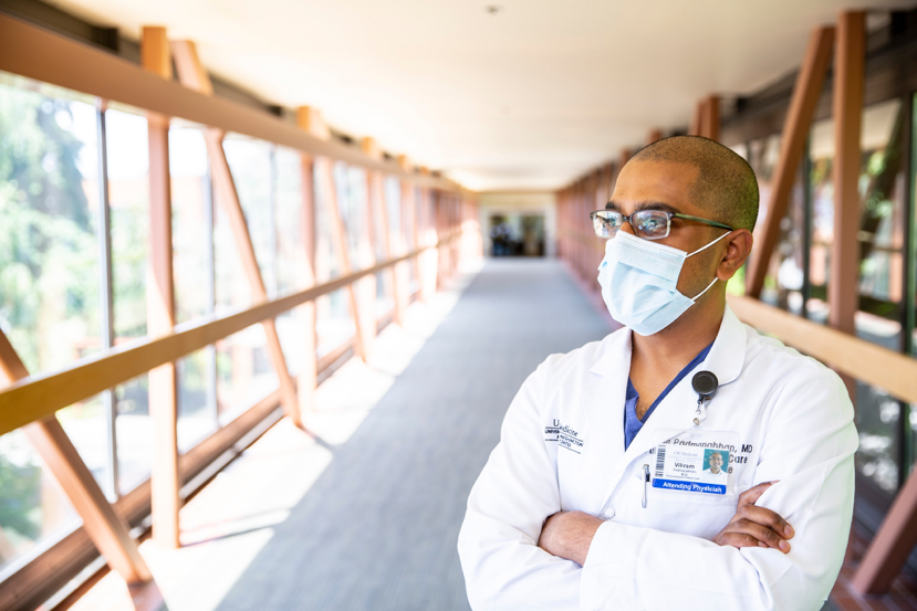 doctor with a mask standing in a hallway